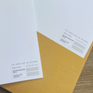 A close up photo of the bottom of the VICTVS labelled note paper, with a returns box at the bottom of the paper allowing invigilators to sign their initials and date of collection